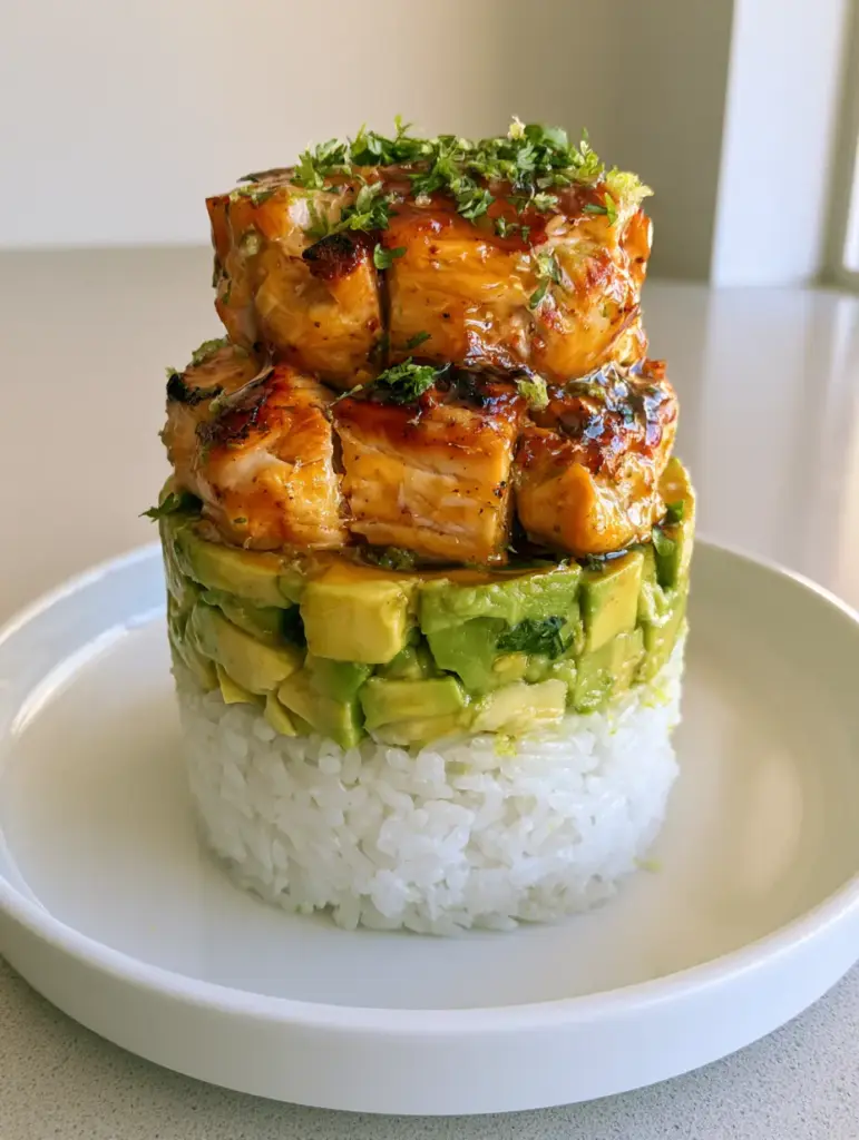 Top-down view of the Honey Lime Chicken Rice Stack showing the glossy glaze and fresh lime zest flakes.