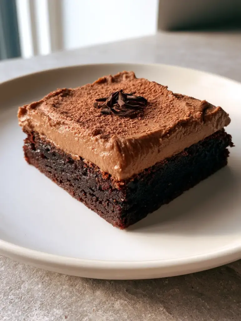 Handheld smartphone photo of a single thick square Coffee Brownie with a 2-inch fudgy base. (Coffee Brownies)