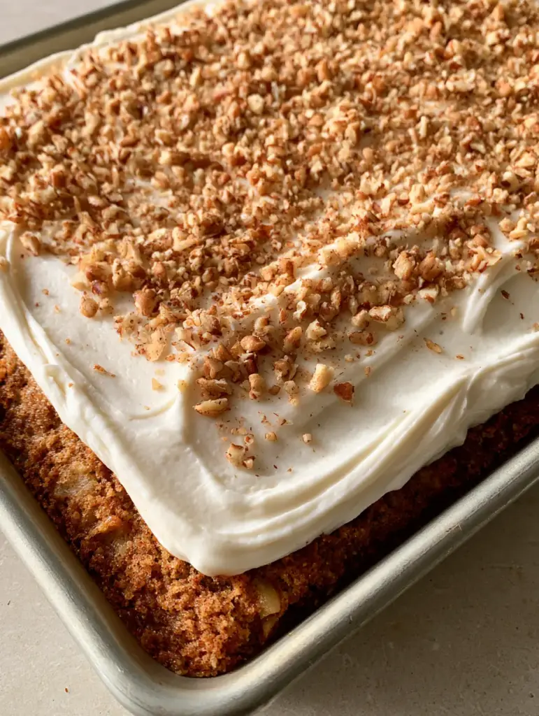 Overhead view of a Hummingbird Sheet Cake showing the golden-brown crumb flecked with pineapple and banana.